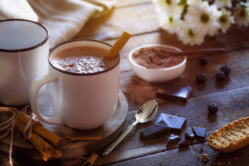 hot coffee decorated with cinnamon powder