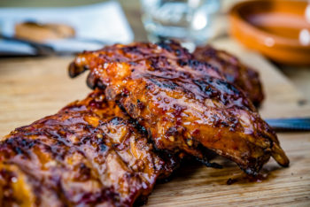 fresh barbecue ribs on a wooden slab