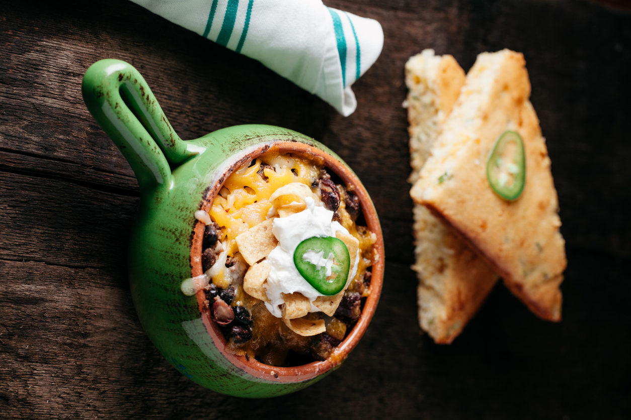 Texas Frito Pie with beef chili, cheese, and sour cream served with corn bread | Frito pie near Lone Tree