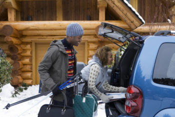 couple packing their car at a ski lodge | winter sports shops