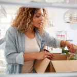 view from inside the refrigerator of a woman unpacking her meal prep delivery service box | meal prep services in Lone Tree