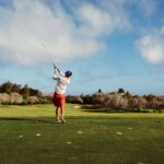 man taking a swing on a golf course | golf schools Lone Tree