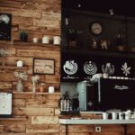 wall of a coffee shop with decorations, a coffee machine, and cups | Lone Tree cafes