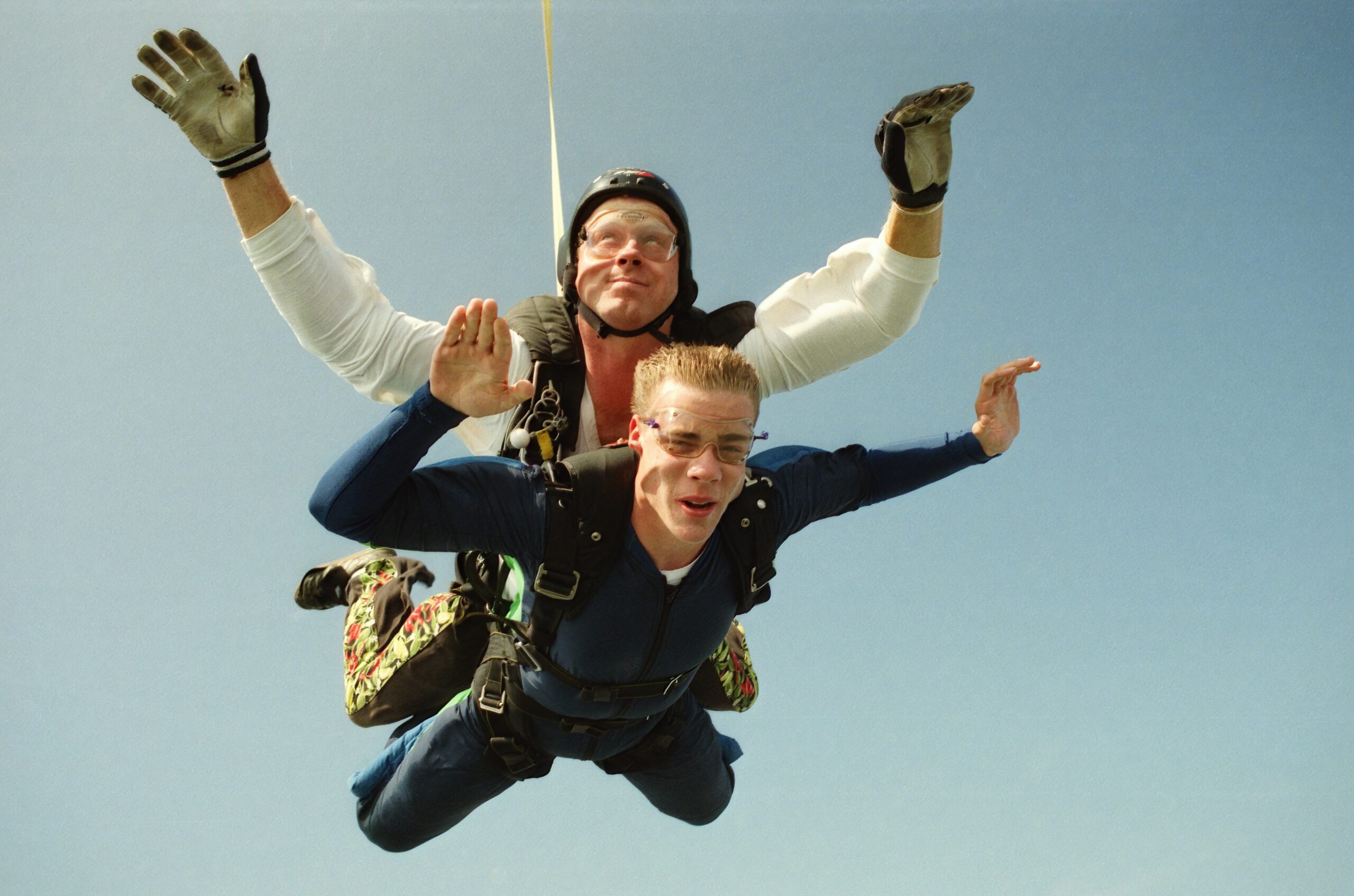 two men skydiving with gear and goggles and smiling | indoor skydiving Lone Tree
