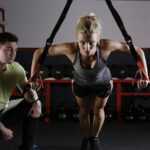 personal training coaching a woman through a work out | fitness Lone Tree