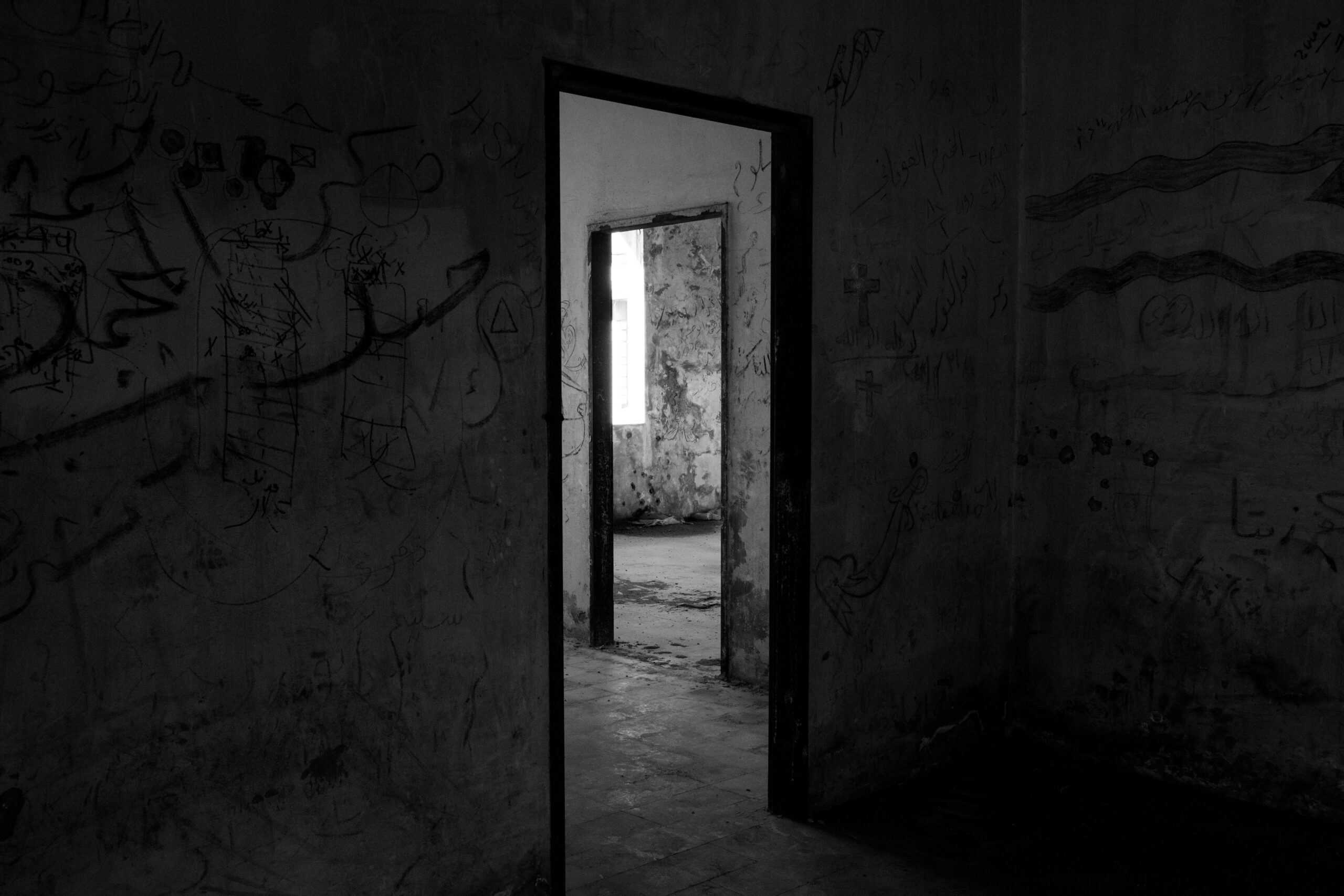 black and white image of a door frame in a spooky looking house | haunted houses Lone Tree