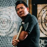 man holding an axe in front of a target | axe throwing Lone Tree